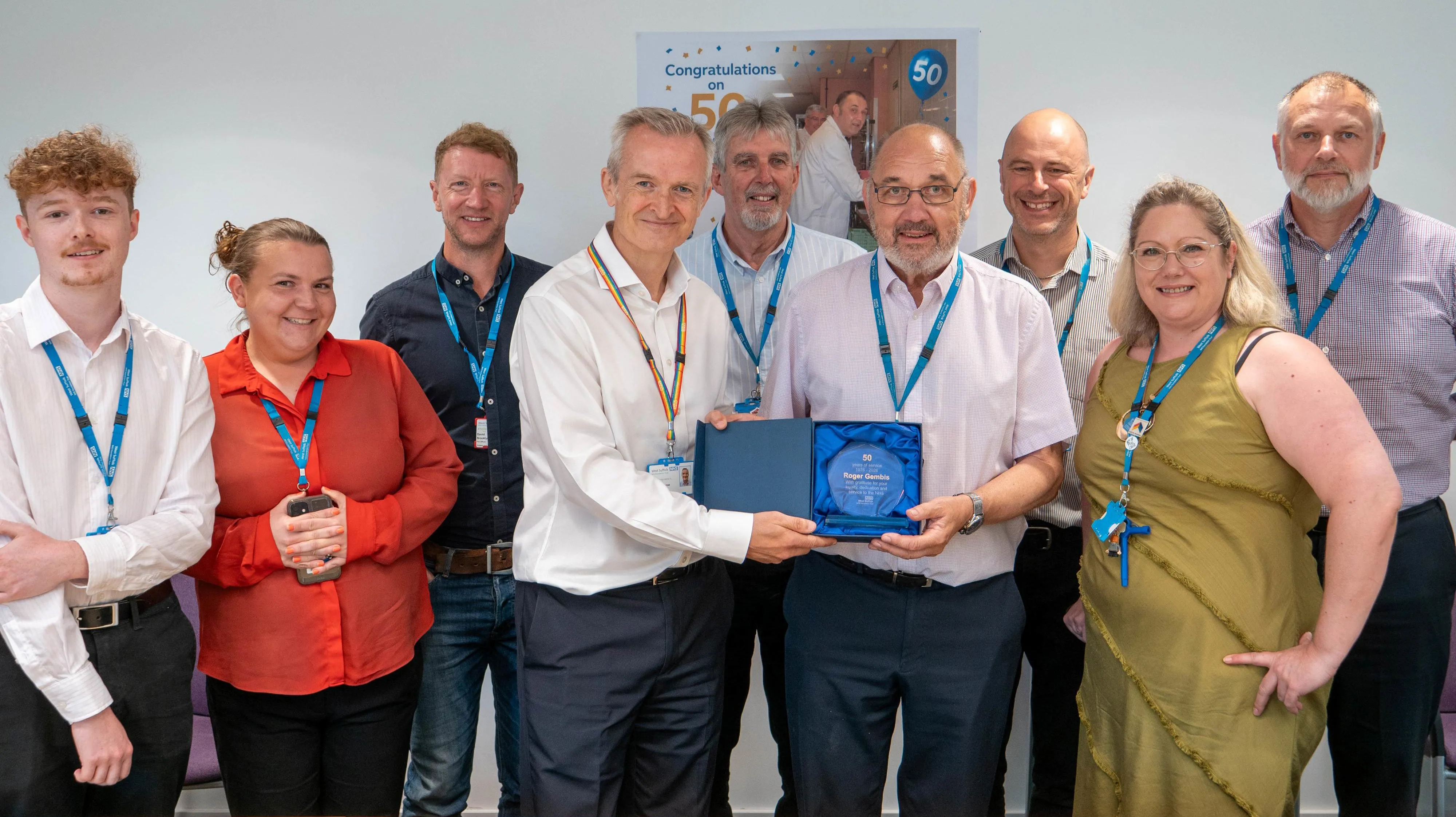 Roger Gembis holding his trophy with chief executive Ewen Cameron and estates colleagues