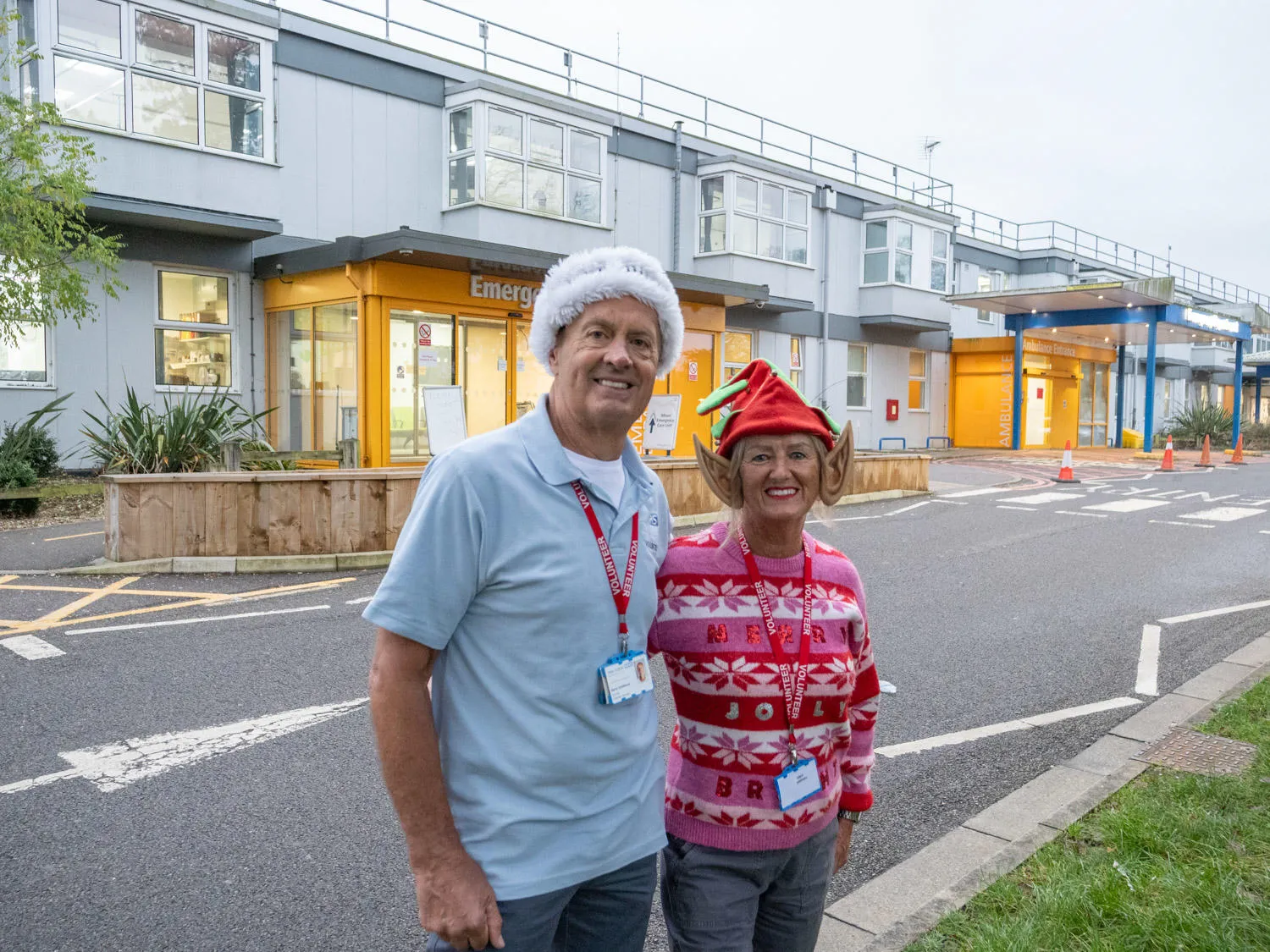 Two volunteers standing outside West Suffolk Hospital