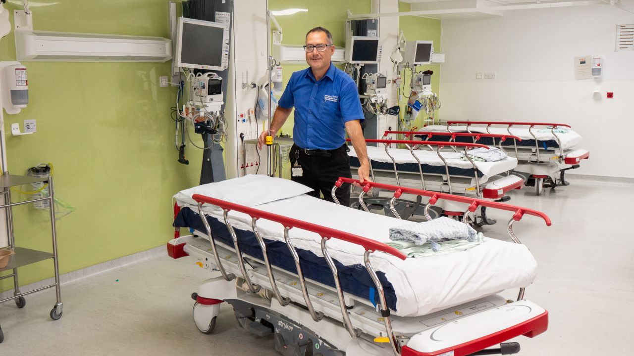 Porter standing by a hospital bed