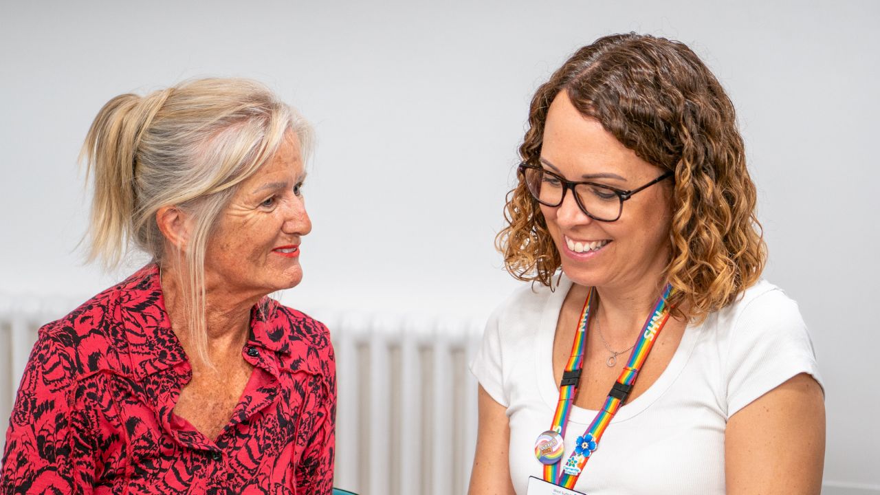 A patient and a member of staff talking together