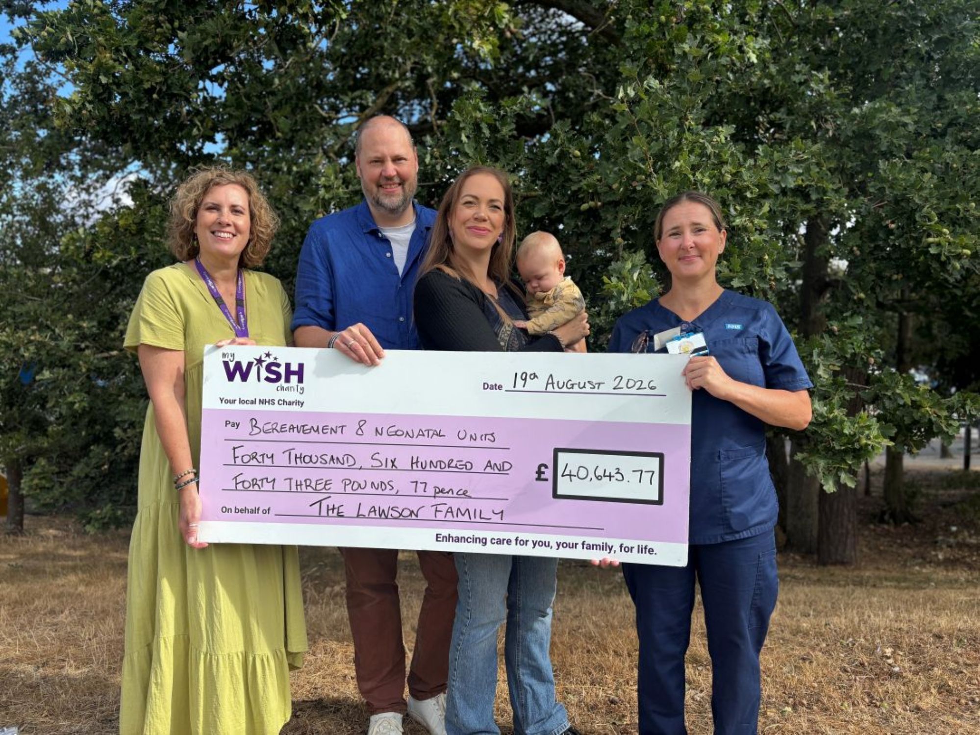 Rhiannon mike and lochlan handing over a giant cheque for £40,643.77