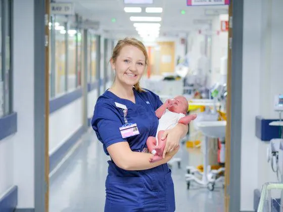 Midwife holding a baby