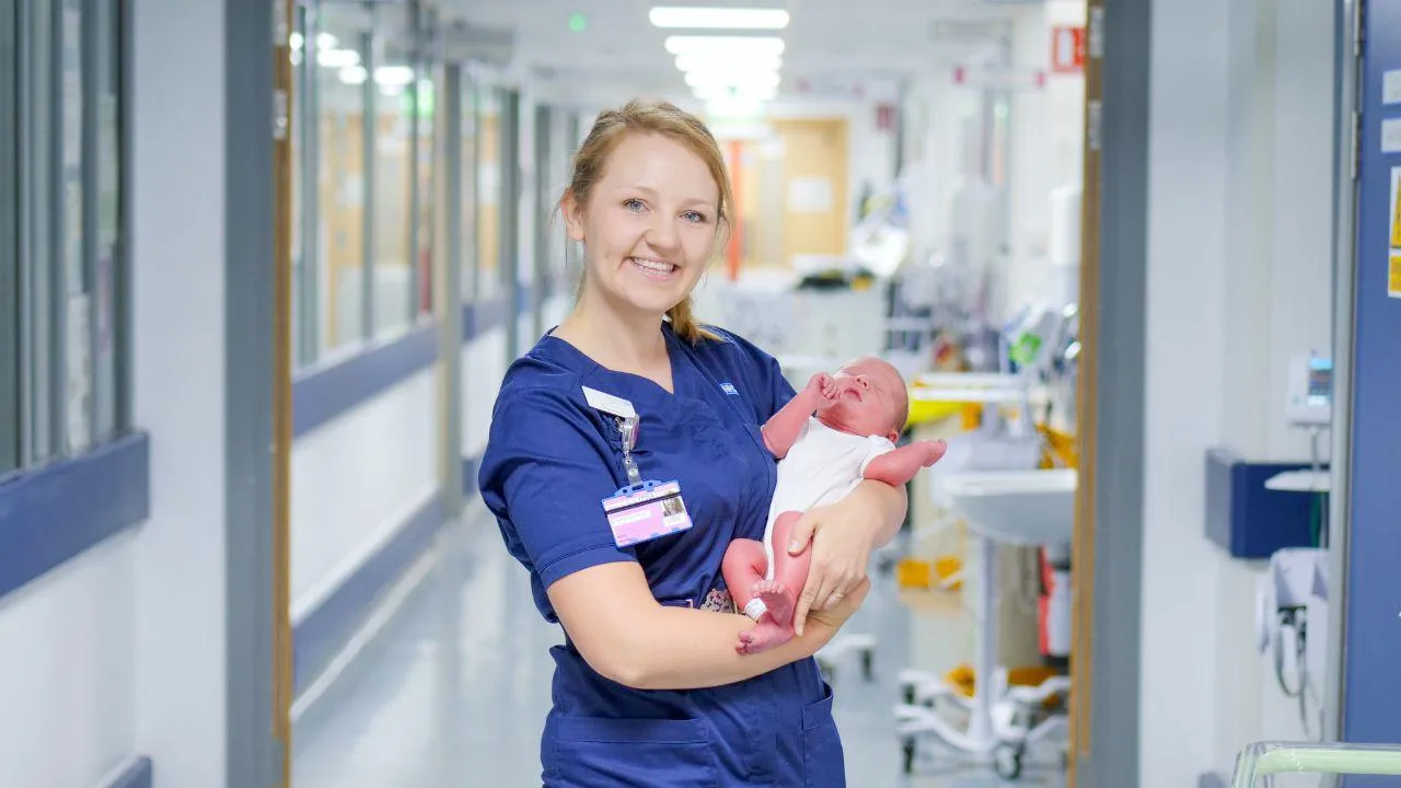 Midwife holding a baby