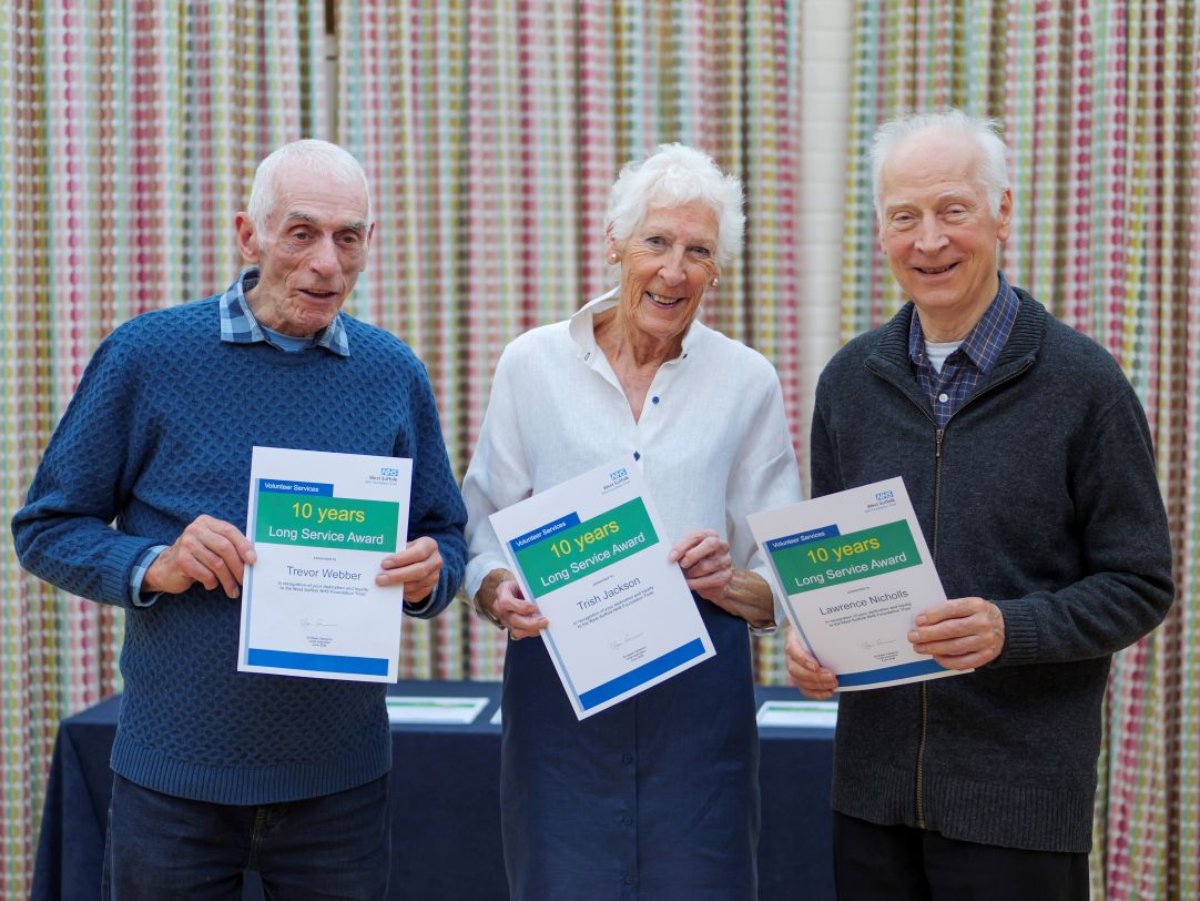 trish, trevor and lawrence holding up their certificates and smiling