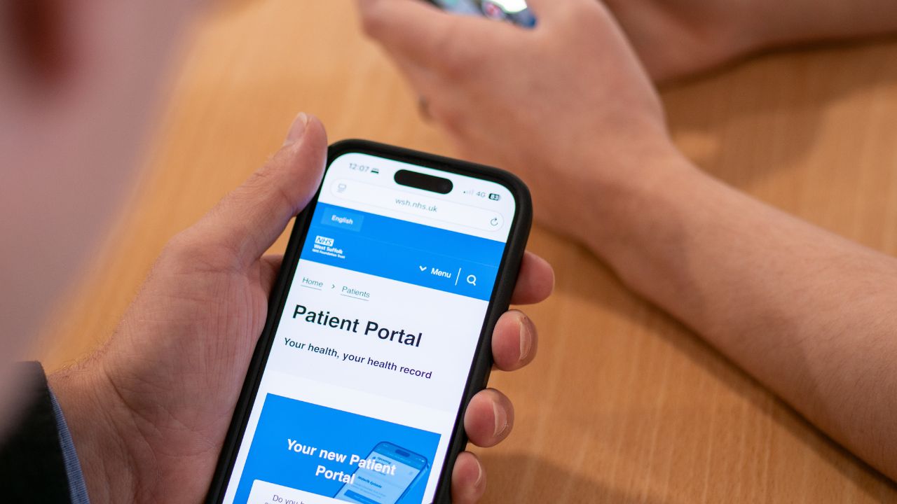 Man holding phone displaying the patient portal service
