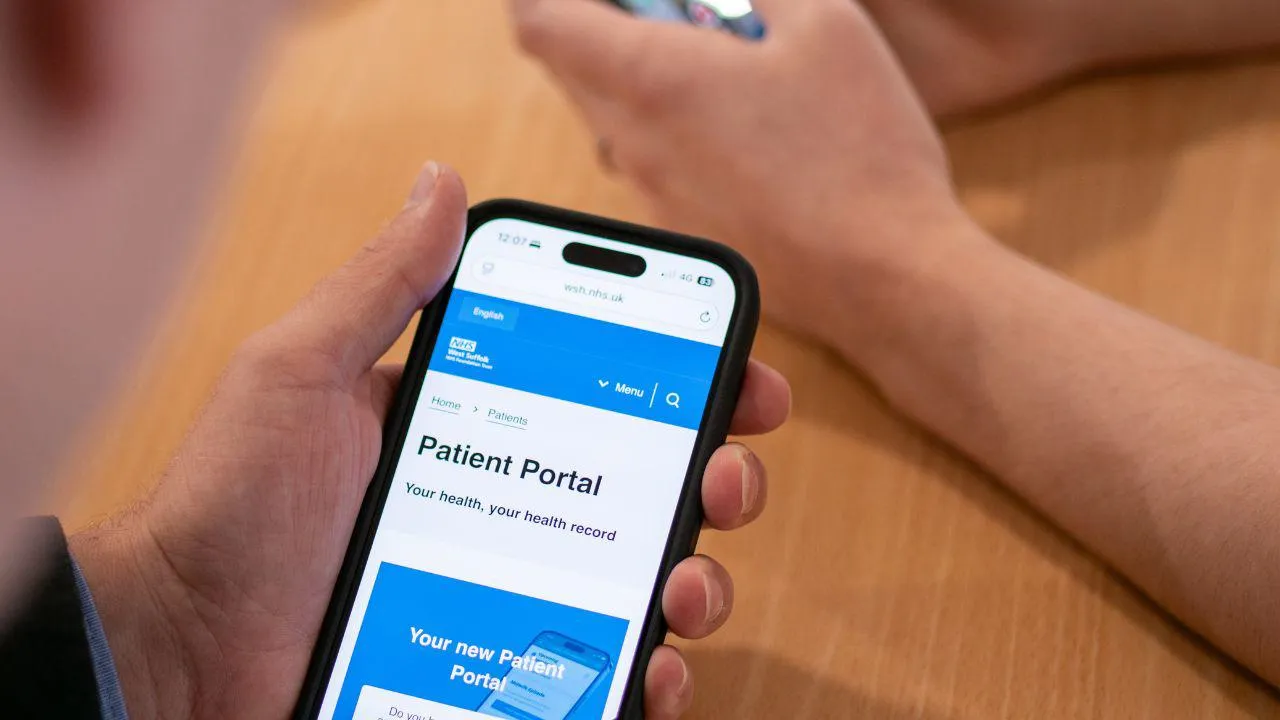 Man holding phone displaying the patient portal service