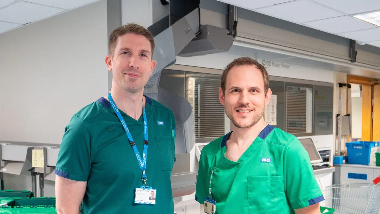 Two pharmacists standing in a hospital pharmacy