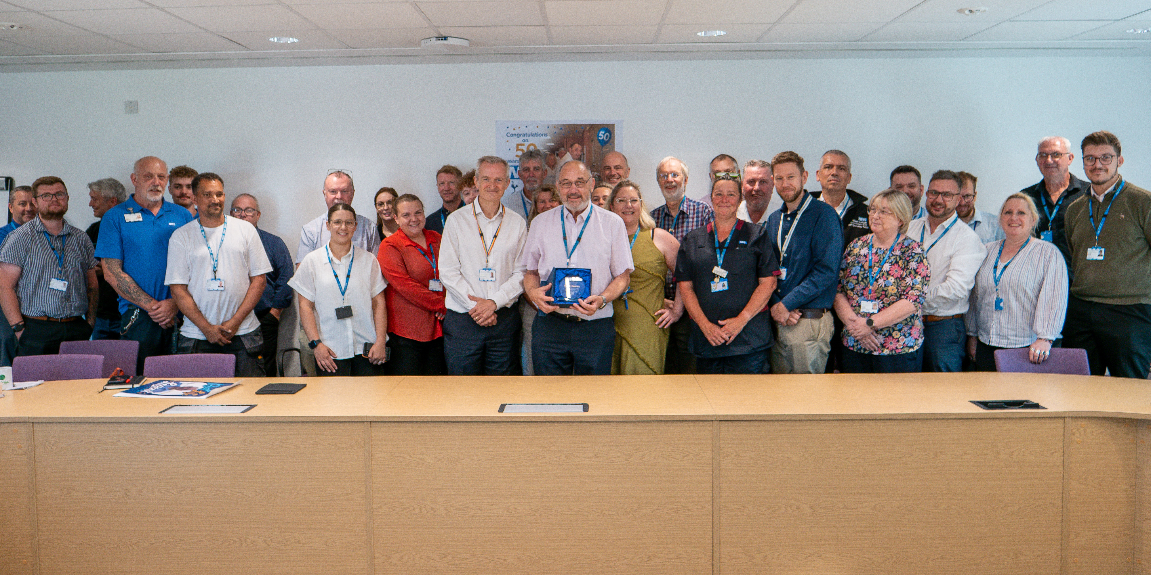 Roger Gembis holding his trophy with the wider estates team