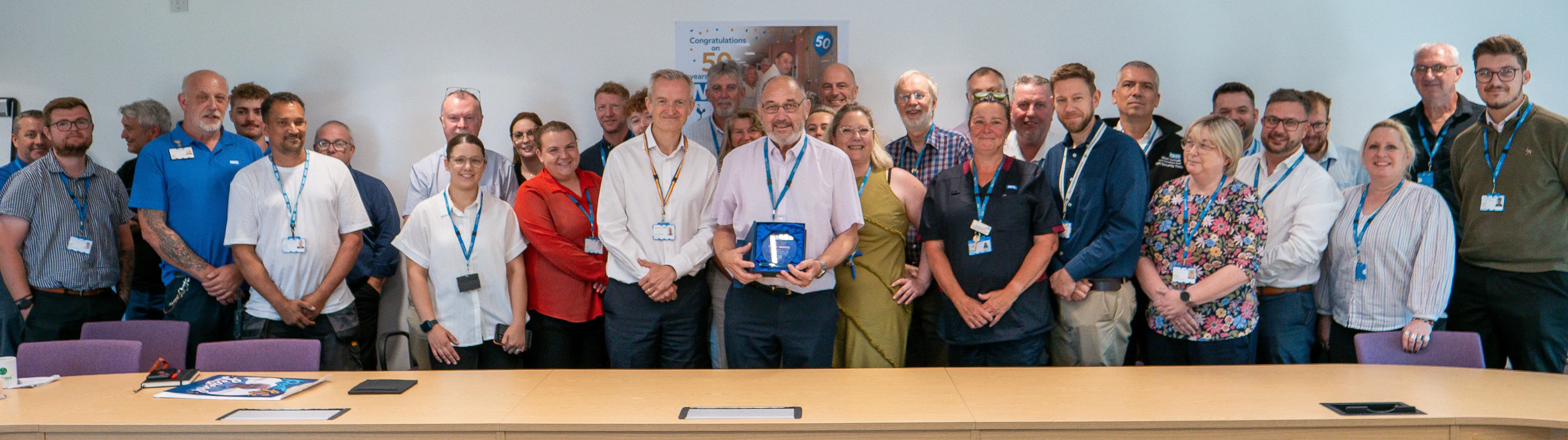 Roger Gembis holding his trophy with the wider estates team