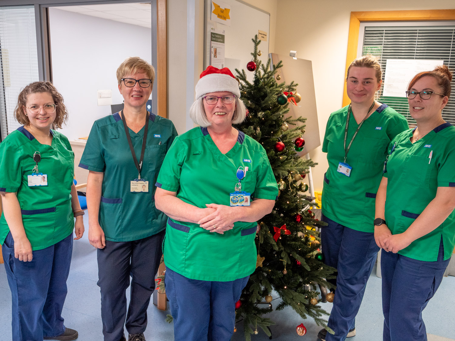 Five pharmacists stood in front of Christmas Tree