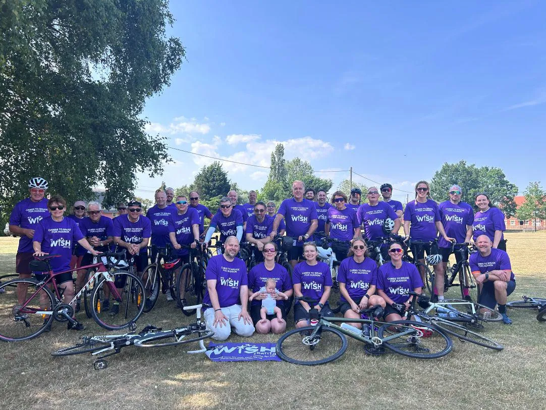 The team of cyclists wearing purple t shirts with My WiSH Charity on them