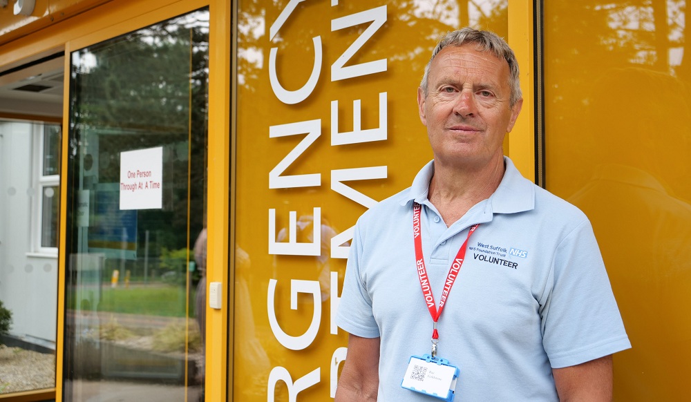 Volunteer standing outside the Emergency Department entrance