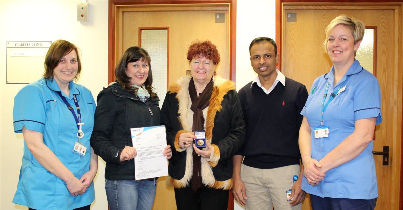 Valeria Cook, centre, with her daughter and staff from the diabetes unit.