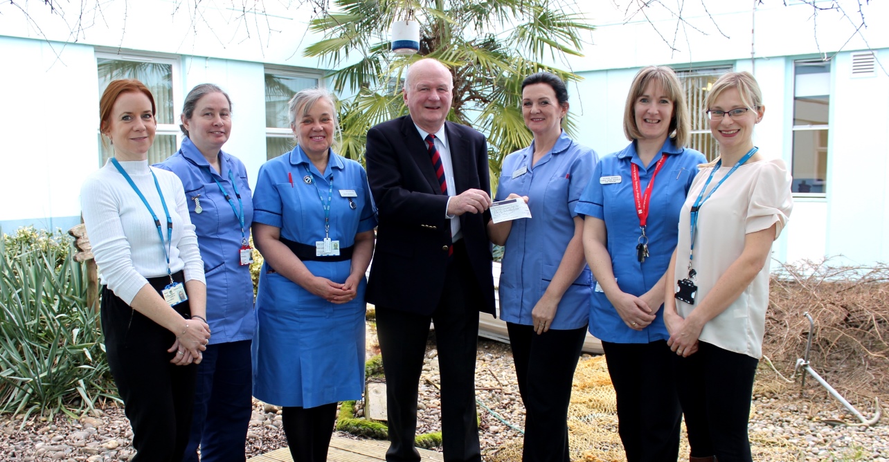 David Kelly, co-founder of A Way With Pain, presents Dawn Pretty, lead clinical nurse specialist in the department of pain medicine, with the donation