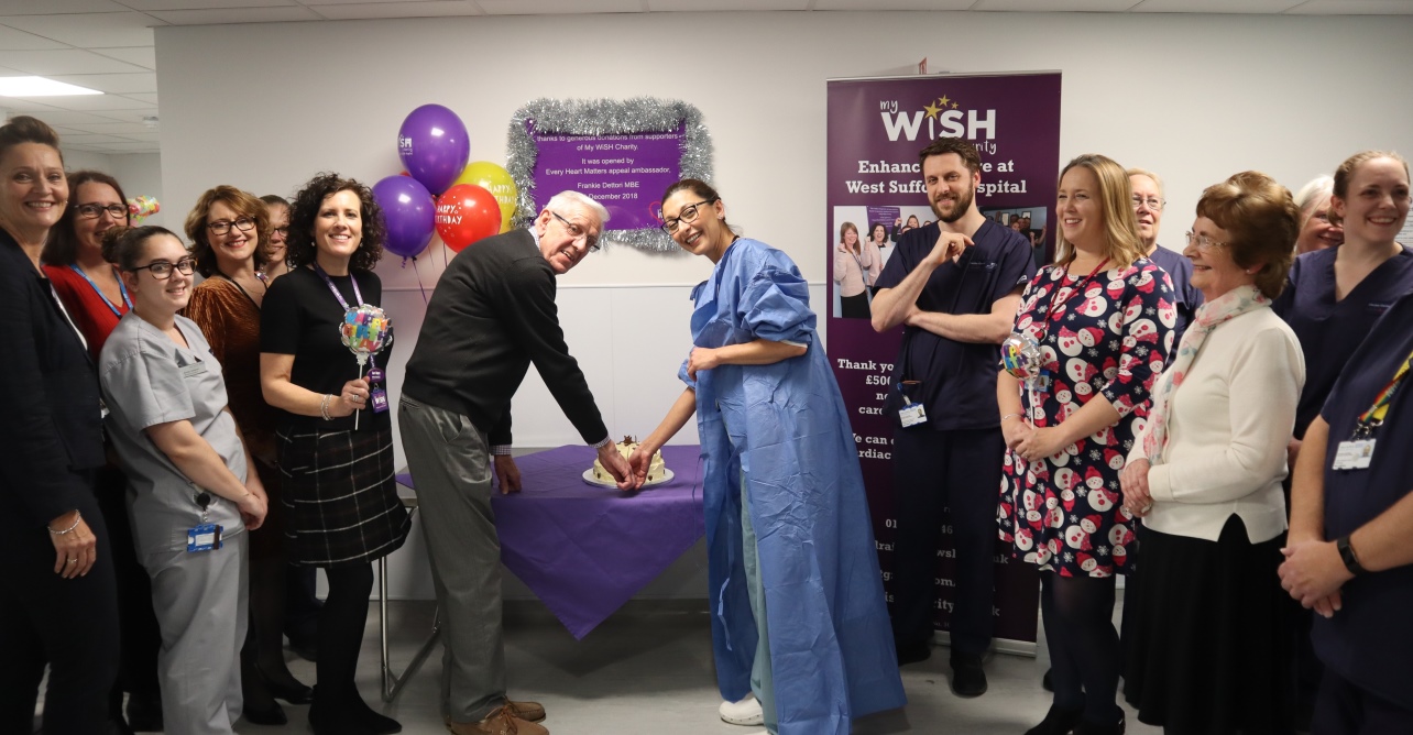 One year celebrations at the WSFT cardiac centre, Dr Salahshouri and ex-patient, Michael, are cutting the cake.
