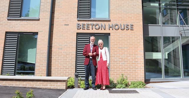 Nigel and his wife Carol are pictured outside one of the new accommodation blocks opened at the hospital in June 2019 which is named in his honour