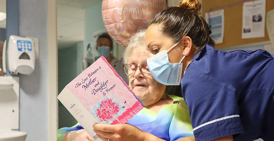 Doris watches her daughter Mel get married by video link