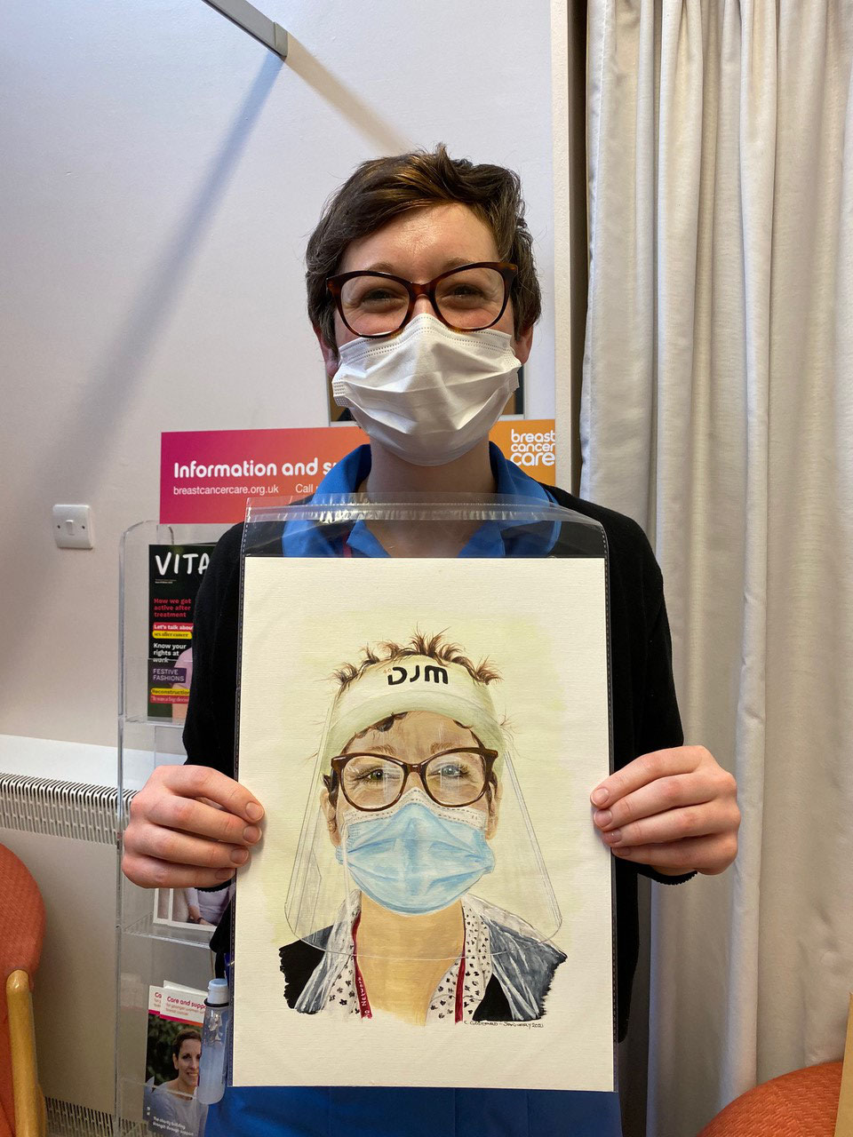 Nurse Ellie Gosbee with the portrait of her painted by grateful patient Chris Goddard